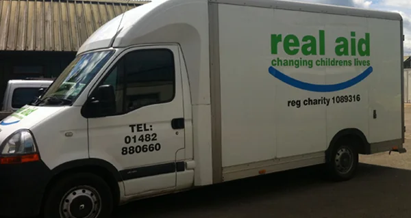 A Real Aid van, liveried with the charity's logo